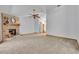 Open living room with a brick fireplace, neutral carpet, and views into the hallway at 715 Oak Ter, Orange City, FL 32763