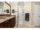 Bathroom showcasing a walk-in shower and a granite countertop vanity at 7462 Se 172Nd Fieldcrest St, The Villages, FL 32162