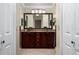 Elegant bathroom featuring double vanities and granite countertops at 7462 Se 172Nd Fieldcrest St, The Villages, FL 32162