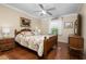 Charming bedroom features hardwood floors, ceiling fan, and a bright window at 7462 Se 172Nd Fieldcrest St, The Villages, FL 32162