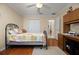 Bedroom features ceiling fan, a work space, closet space, and access to another room at 7462 Se 172Nd Fieldcrest St, The Villages, FL 32162