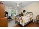 Bedroom features a work space, a window with blinds and curtains, and a ceiling fan at 7462 Se 172Nd Fieldcrest St, The Villages, FL 32162