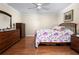 Spacious bedroom with hardwood floors, ceiling fan, and comfortable bed at 7462 Se 172Nd Fieldcrest St, The Villages, FL 32162