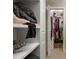 Organized closet with shelving and hanging storage for clothes and accessories at 7462 Se 172Nd Fieldcrest St, The Villages, FL 32162