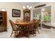 Traditional dining area with a wood table, cabinet, and view of the sunroom at 7462 Se 172Nd Fieldcrest St, The Villages, FL 32162