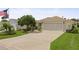 Charming single-story home featuring a well-manicured lawn and an attached two-car garage at 7462 Se 172Nd Fieldcrest St, The Villages, FL 32162