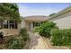 Charming home with a well-manicured front yard, mature landscaping, and walkway leading to the entrance at 7462 Se 172Nd Fieldcrest St, The Villages, FL 32162