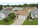Traditional one story home boasts manicured lawn, front garden, and a two car garage at 7462 Se 172Nd Fieldcrest St, The Villages, FL 32162