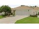 Spacious garage with concrete driveway and well-maintained landscaping at 7462 Se 172Nd Fieldcrest St, The Villages, FL 32162