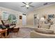 Cozy living room with vaulted ceilings, neutral color scheme, round rug, and comfortable seating area at 7462 Se 172Nd Fieldcrest St, The Villages, FL 32162