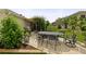 Enjoy this home's relaxing backyard patio with comfortable seating, barbecue, and meticulous landscaping at 7462 Se 172Nd Fieldcrest St, The Villages, FL 32162
