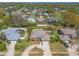 Aerial view of a well maintained single story home featuring a circular driveway and lush landscaping in a suburban neighborhood at 811 Smokerise Blvd, Port Orange, FL 32127