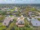 An aerial shot reveals a one-story home featuring a brick chimney, rear patio and trampoline in a leafy neighborhood at 811 Smokerise Blvd, Port Orange, FL 32127