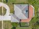 Aerial view of a home with a circular driveway and a spacious backyard with a canal at 811 Smokerise Blvd, Port Orange, FL 32127