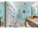 Bright bathroom featuring a shower with nautical-themed decor at 811 Smokerise Blvd, Port Orange, FL 32127