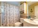 Well-lit bathroom featuring a shower with nautical-themed accents and a white vanity at 811 Smokerise Blvd, Port Orange, FL 32127