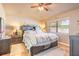 Comfortable bedroom with wood flooring, a large window, and neutral decor at 811 Smokerise Blvd, Port Orange, FL 32127