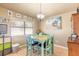 Cozy dining area with wood floors, bright window, and a charming dining set at 811 Smokerise Blvd, Port Orange, FL 32127