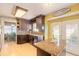 Well-appointed kitchen with island, updated cabinets, granite counters, and stainless appliances at 811 Smokerise Blvd, Port Orange, FL 32127