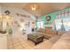 Open living room with turquoise accent wall, tile floor, and access to other rooms at 811 Smokerise Blvd, Port Orange, FL 32127