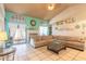 Bright living room featuring tile flooring, coastal decor, and sliding glass doors to the patio at 811 Smokerise Blvd, Port Orange, FL 32127