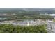 Wide community aerial view showcasing the ponds and lush green tree coverage at 9033 Cape Cod Rd, Deland, FL 32724