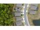 Aerial view of a house with solar panels, a fenced backyard with play equipment, and lush surrounding greenery at 9033 Cape Cod Rd, Deland, FL 32724
