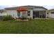 Landscaped backyard with a patio seating area and covered patio at 9033 Cape Cod Rd, Deland, FL 32724