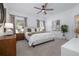 Bright bedroom with a large bed, contemporary furnishings, and neutral decor at 9033 Cape Cod Rd, Deland, FL 32724