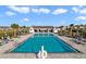 Resort-style community pool surrounded by lounge chairs, palm trees, and a covered pavilion at 9033 Cape Cod Rd, Deland, FL 32724