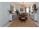 Elegant dining room featuring a large wooden table, neutral walls, and sophisticated decor at 9033 Cape Cod Rd, Deland, FL 32724
