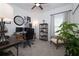 Functional home office with a desk, computer setup, comfortable chair, shelving unit, neutral tones, and ample natural light at 9033 Cape Cod Rd, Deland, FL 32724