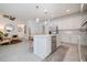 Bright kitchen featuring stainless steel appliances, white cabinets, and a spacious center island at 9033 Cape Cod Rd, Deland, FL 32724