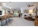 Open-concept living area features tile floors, bar seating, and a seamless flow to the outdoors at 9033 Cape Cod Rd, Deland, FL 32724