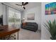 Bright office space with a large window, comfortable seating, and a modern desk at 9033 Cape Cod Rd, Deland, FL 32724