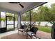 Relaxing screened patio with comfortable seating, ceiling fan, outdoor furniture, and a view of the well-maintained backyard at 9033 Cape Cod Rd, Deland, FL 32724