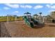 Community playground with slides, a swing set, and a safety-first wood chip ground cover at 9033 Cape Cod Rd, Deland, FL 32724
