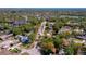 An aerial view of a cozy home near a lake and the ocean in a lush, green neighborhood at 912 Tree Garden Dr, Port Orange, FL 32127