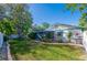 Fenced backyard with lush lawn, plants, and greenery at 912 Tree Garden Dr, Port Orange, FL 32127