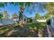 Grassy backyard features a large tree and a white fence at 912 Tree Garden Dr, Port Orange, FL 32127