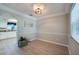 This dining room has an arched doorway into the kitchen, wood-look floors, and lots of light at 912 Tree Garden Dr, Port Orange, FL 32127