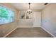 This dining room has a window bringing in natural light and sleek wood-look floors at 912 Tree Garden Dr, Port Orange, FL 32127