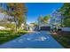 Inviting one-story home with a long driveway leading to an attached garage at 912 Tree Garden Dr, Port Orange, FL 32127