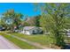 Front exterior of a home with a large grassy yard and trees at 912 Tree Garden Dr, Port Orange, FL 32127
