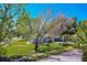 Charming single-story home featuring a well-manicured lawn and mature trees providing shade at 912 Tree Garden Dr, Port Orange, FL 32127