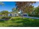 Charming single-story home featuring a well-manicured lawn and lush landscaping at 912 Tree Garden Dr, Port Orange, FL 32127