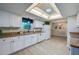 Bright kitchen with white cabinets, modern appliances, updated countertops, and a skylight at 912 Tree Garden Dr, Port Orange, FL 32127