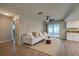 Bright living room with stylish white sofa, area rug, ceiling fan and sliding glass door to the outside at 912 Tree Garden Dr, Port Orange, FL 32127