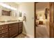 Bathroom with vanity, granite counters, framed mirror, and view into the bedroom at 929 Torchwood Dr, Deland, FL 32724