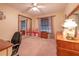 Bedroom featuring a ceiling fan, carpeted floors, blinds, and a sliding mirror door to the closet at 929 Torchwood Dr, Deland, FL 32724